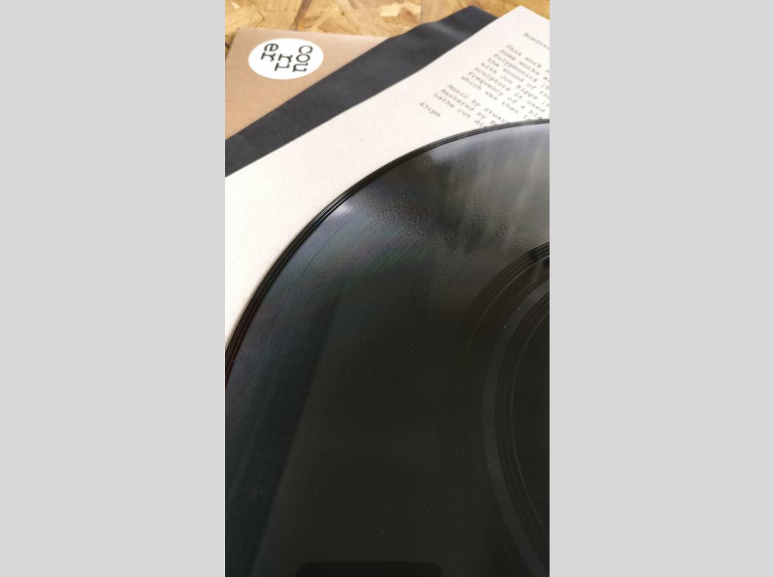 Close up photograph on vinyl record and cover